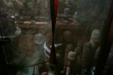 concealed behind gauze curtains, part of the temples penis collection.