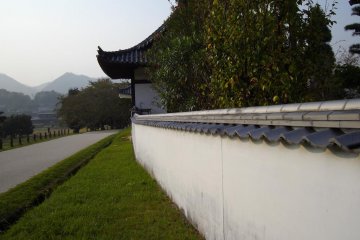 The long white wall the surrounds the temple which leads to Bitchu Kokubunji