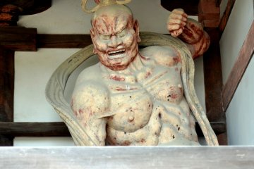 Statue of one of a pair of fierce guardian gods, keeping his mouth opening