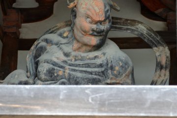 The other one of the pair of fierce guardian gods, keeping his mouth closing