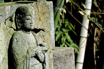 <p>One of the small jizo statues sitting in its final resting place</p>