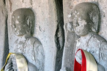 <p>Close-up look at two of six jizo statues at the entrance</p>