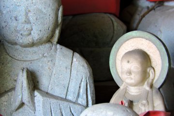 <p>In a group of small jizo statues there's a much smaller one, which looks like a child's statue</p>