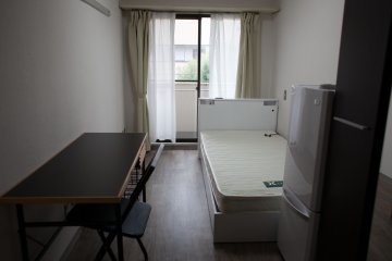 <p>房间内配有桌椅，冰箱和门厅</p>