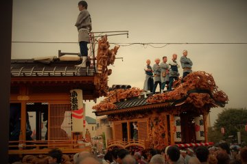 <p>Tough guys stand atop the floats, trying to intimidate other teams before battle</p>
