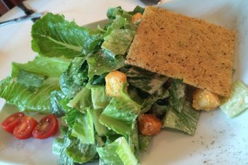 <p>The Caesar Salad doesn't look all that glamorous, but it was definitely tasty being&nbsp;topped off with a thin block of parmesan cheese</p>