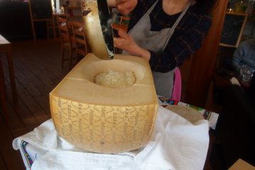 <p>This is their statement dish - Cheese risotto finished off inside the half wheel of Parmigiano</p>