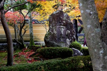 A stone monument under the maples