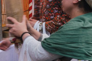 <p>People who come to the shrine throws coins into the box and then pulls and shakes the rope to ring the bell.</p>