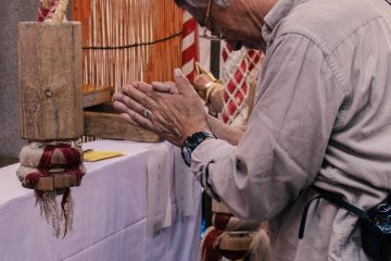 <p>After tugging the rope they clap and put their hands together to pray.</p>