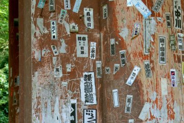 <p>Stickers pasted onto the gate by pilgrims visiting the temple</p>