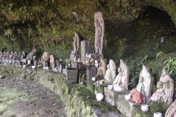 <p>Inside this small cave, you will find many various Buddhist statues in contrast to the stone relief out front.</p>