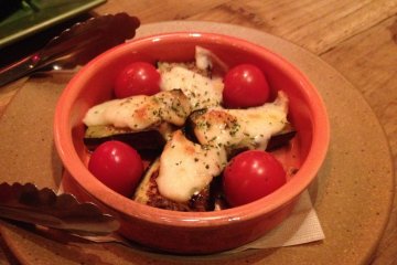 <p>Roasted aubergine with cheese and tomatoes</p>