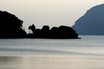 <p>A small peninsula appears as a black silhouette</p>