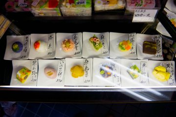 <p>The menu is shown from a glass case</p>