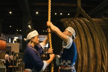 <p>Upon entering you are greeted by an impressive depiction of workers hoisting up a barrel thru the second floor</p>