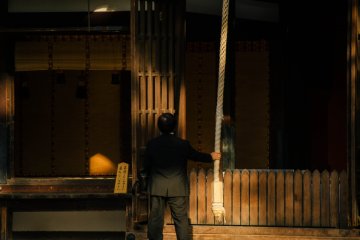 <p>A man ringing the bell after saying his prayers.</p>
