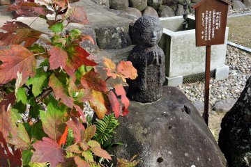 <p>Cute jizo statue and colorful autumn leaves. This jizo is said to smile when you pour water on his head, and is popular among tourists, especially women.</p>