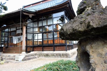 <p>Old stone lantern and the main temple building</p>