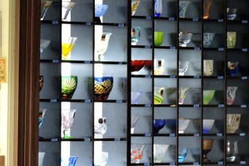 <p>Beautiful faceted glasses line the shelves</p>