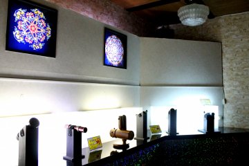 <p>By the wall, you will see the symmetrical colors and light formations from some of the kaleidoscopes captured in enlarged pictures.</p>