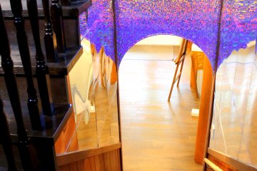 <p>The stairs going back to the first floor with wall designs patterned after the art formations found inside the kaleidoscopes</p>