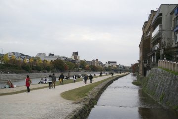 <p>The cloudy weather didn't stop people from walking along Kamogawa</p>