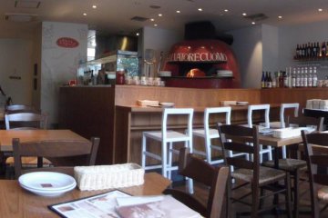 The open kitchen allows you to watch the chefs prepare your food