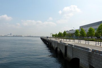 There is the sea, the promenade, and the grass and trees.