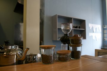 <p>Fresh coffee beans by the counter</p>