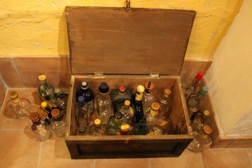 <p>Chest full of empty mezcal bottles</p>