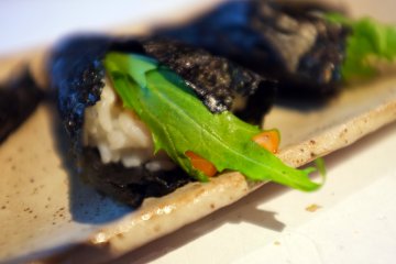 <p>The temaki is served with fresh mizuna (water greens) leaves</p>