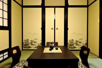 <p>I loved the illustrations of pines and rocks on the doors in the living room. This low table is the kotatsu, but sadly I didn't get a photo of it after the kotatsu blanket was added.</p>