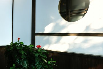 <p>Beautiful round-shaped window cut out of a white wall</p>