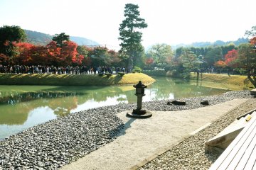 <p>The view seen from central chamber of Phoenix Hall. On the opposite side of the pond there is a long line of people waiting for their turn to enter the Phoenix Hall</p>