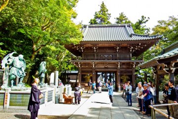 <p>Looking back at Shitenno-mon Gate from within inside Yakuo-in Temple`s inner grounds. Notice the Buddhist Monk standing beside two large scary looking statues of Tengu, (Mountain Demons)</p>