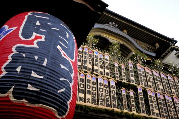 <p>Huge paper lanterns hang outside the theater</p>
