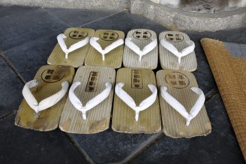 <p>You can see wear and tear on the wooden soles of the sandals</p>
