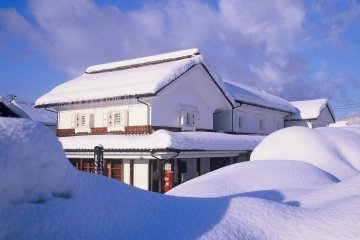 Snow covered village house