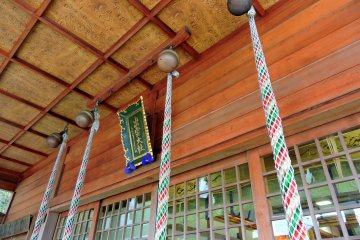 <p>Looking up at the prayer bells and the colorful bell ropes</p>