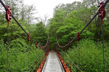 This small red bridge crosses a river on the way to the lake.