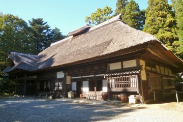 <p>Visitors can explore this thatched-roof home.</p>