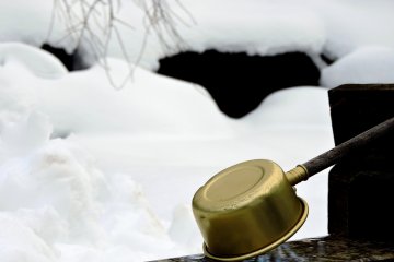 <p>Ladle on the water purification font with snow in the background</p>