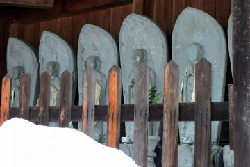 <p>Six jizo statues at the entrance of Taichoji Temple. Notice the mountain of snow in front of it!</p>