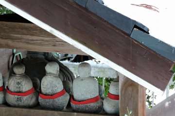 <p>Silent backs of jizo statues</p>