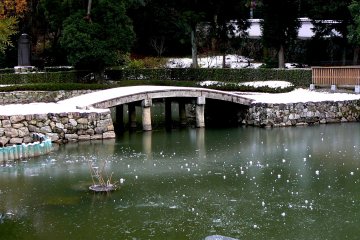 <p>The thin covering of snow on the stone bridge was untouched</p>
