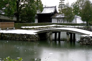 <p>The pond was glazed with ice which held a few lumps of snow here and there</p>