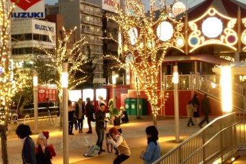 <p>Cosplayers&nbsp;taking photos near the amusement park's merry-go-round</p>