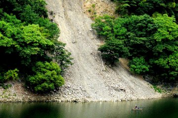 <p>A tiny boat below a scree slide</p>