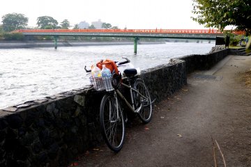 <p>My bike leaning against the stone wall along the river bank at Uji</p>